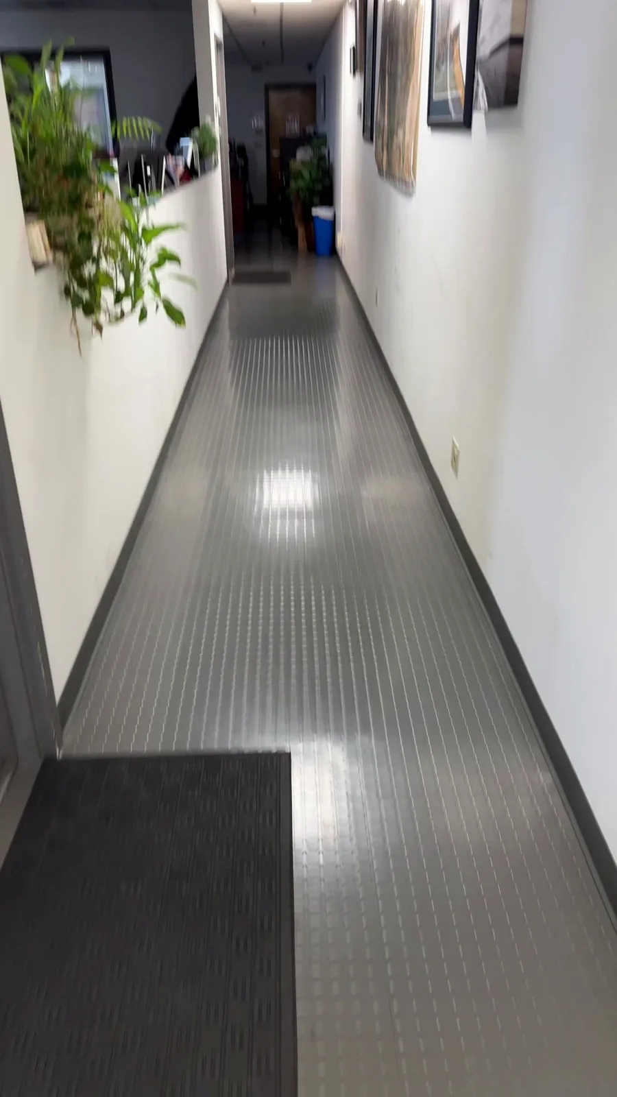 A clean office and facility hallway with a polished floor